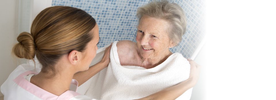 caregiver assists the elderly for bathing
